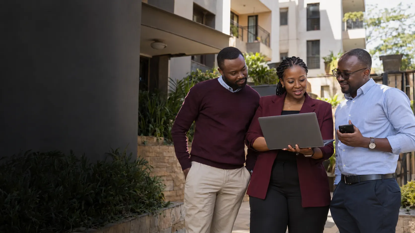 Kenyan property team reviewing rental operations outside Nairobi apartments